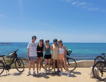 Students biking in Palma de Mallorca by the beach