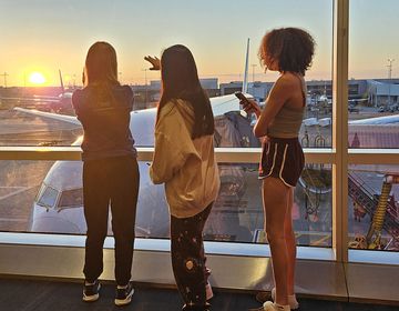 Teenagers watching the sunset from the airport