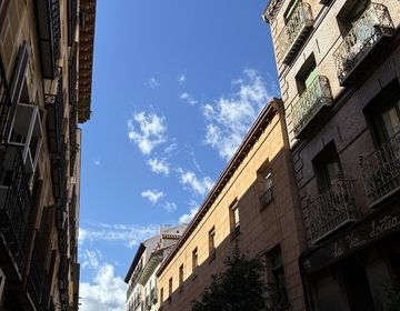 Sunny Madrid street, half in shadow.