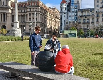 Students having a conversation in a local plaza