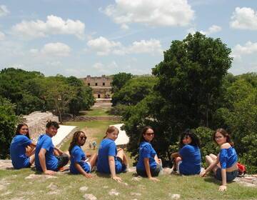 HSSA Students sit on a hill overlooking the ruins of the ancient city of Uxmal