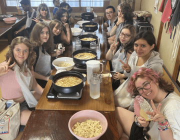 students posing with newly made hoto, a noodles dish
