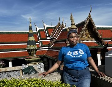 Ciani stands overlooking the grand palace in thailand. it is her first week since moving to thailand from the us