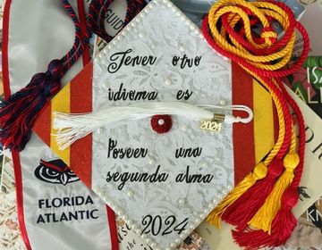 A photo of my decorated university graduation cap with the quote "to speak another language is to possess a second soul" written in spanish.