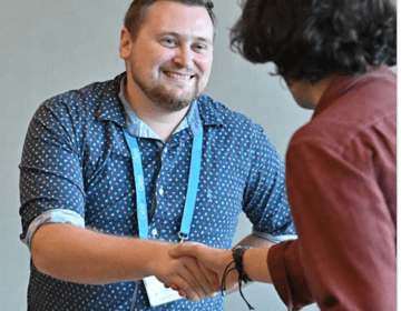 Kel Harper of Six Flags meets a candidate at a CIEE job fair.