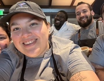 Maria poses with her friends in the Ocean Reef Club kitchen.