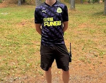 Peter Brimstone stands in the woods of Pierce Camp Birchmont in New Hampshire.