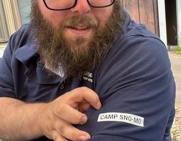 Camp Sno-Mo director Chris Ellis shows off the camp logo on his shirt.