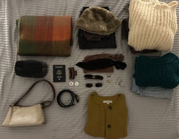 Clothes spread out on a bed