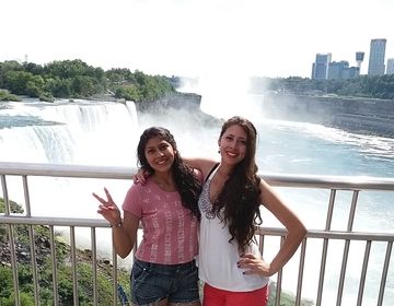 Two Summer Work Travel participants pose in front of Niagara Falls.
