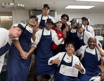 Lungelo K., at bottom right, poses with his coworkers at the Sea Island Company in Georgia. The South African native served as a CIEE BridgeUSA Trainee.