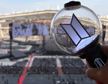 BTS concert stage with ARMY lightstick in front of it