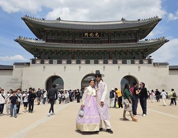Infront Gyeongbokgung Palace with matching Hanboks