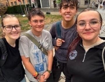 Hannah W. (left) stands with new friends