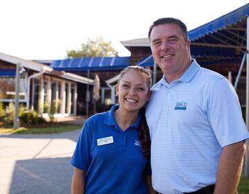 An employer, right, stands with one of his BridgeUSA Summer Work Travel participants.
