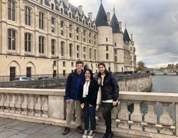 Gap year students group photo beside castle in Paris