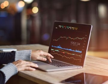 Specialist looking at stocks on a laptop