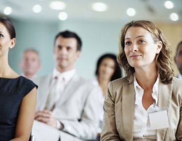 Professionals and scholars listening to a talk at a conference