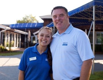 young employee with boss amusement park