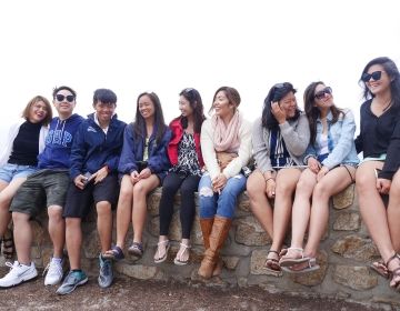 employees sitting on ledge in national park