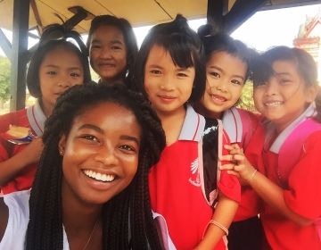 Teacher with group of kids in Thailand