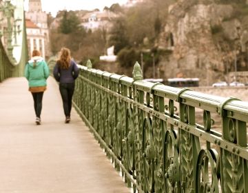 People walking across bridge in Budapest
