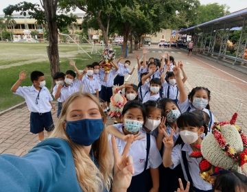 Teacher and students outside in masks in Thailand