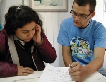 Teacher and student working on assignment together