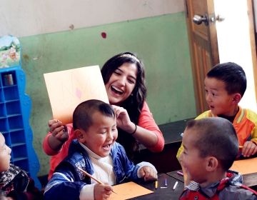 Teacher and young students in classroom in Thailand