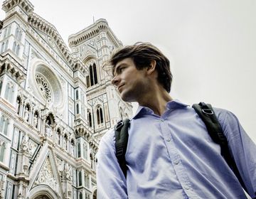 Florence man with backpack in front of cathedral