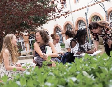 High school students conversing in garden at CIEE Center in Toulouse