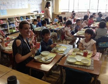 Teacher and students eating lunch at school in Japan