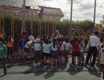 Japanese students outside with teacher on the playground