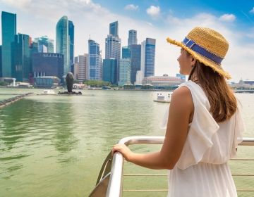 singapore girl on boat looking at buildings