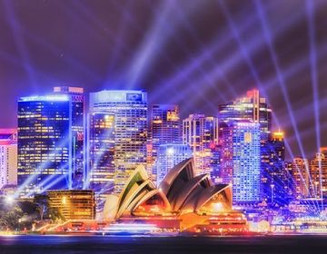 sydney opera house at night with spotlights