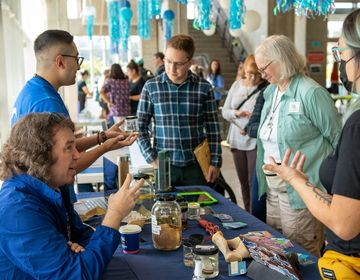A group of people explaining a concept to others at a table