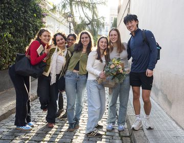 Students smiling in a group on street while studying abroad