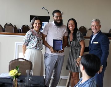 a group of people accepting an award