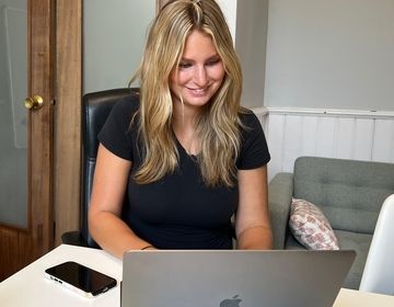 An intern sits at a table during a meeting.