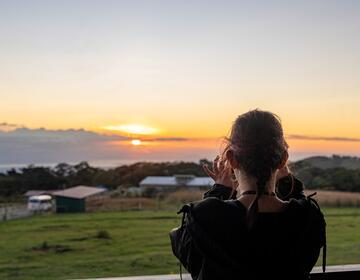 Student taking photo of beautiful sunset in Monteverde