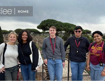 A group of 5 students with red "ASU" lanyards stand in front of historic ruins, with a "CIEE Rome" logo at the top of the photo