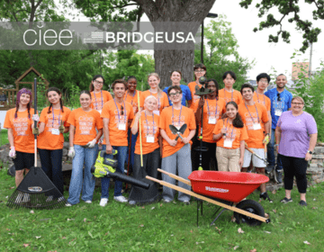 CIEE BridgeUSA Young Civic Leadership Summit participants pose with landscaping tools after a community cleanup in Wisconsin Dells