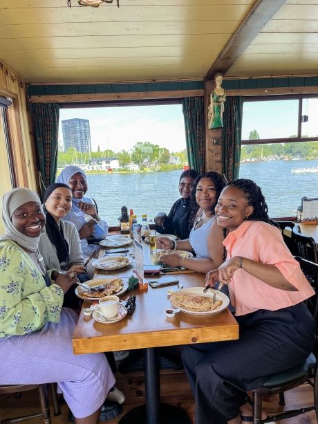 amsterdam students eating on river