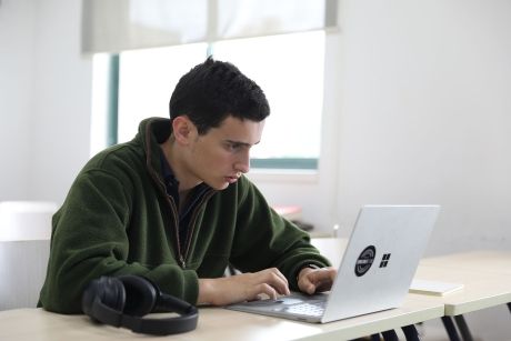 Student looking intently at laptop in class