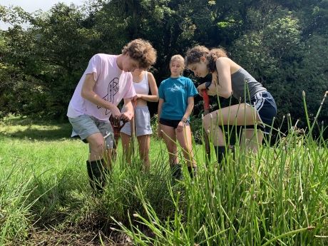 Gap year students shoveling in Monteverde