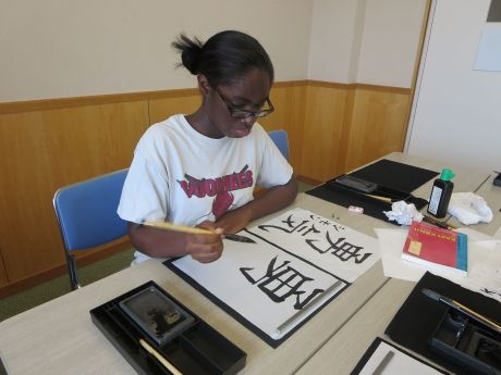 Student practicing kanji in Tokyo classroom