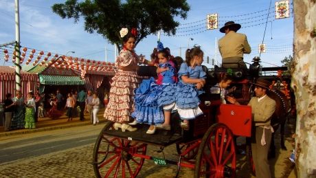 Local girls in costume on carriage in Seville