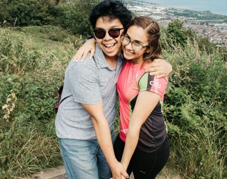 Two students smiling on a mountain