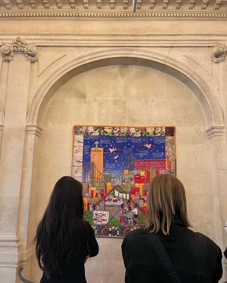 Students looking at a tapestry at a museum in Paris