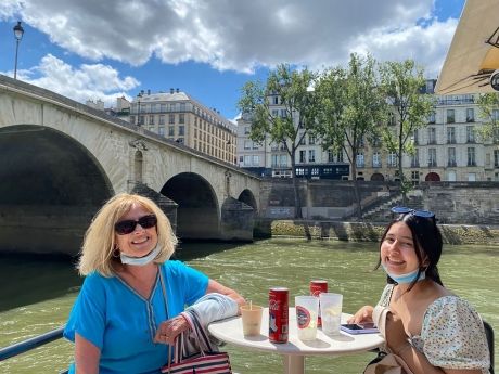 Student and host eating lunch in Paris by the Seine